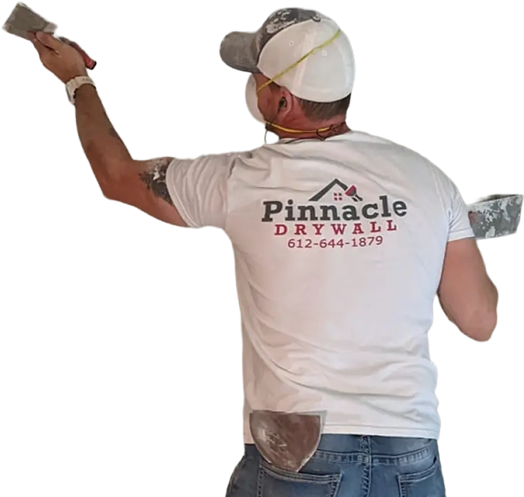Drywall worker applying finishing compound to wall surface during interior drywall work