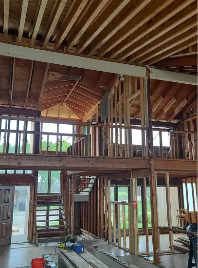 Residential framing structure during early construction phase with exposed wood beams